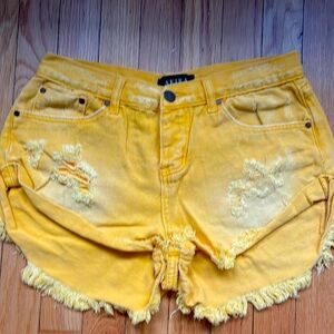 Yellow distressed shorts